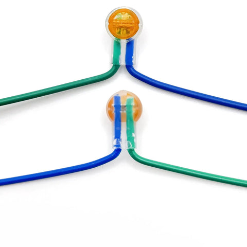 Close-up of Gel Filled Waterproof UY2 K2 Network Cable Connectors for Telephone Wire and Speaker Cable on green and blue wires.
