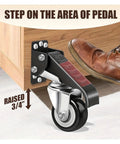 Person using foot pedal to engage Super Tough Heavy Duty Workbench Caster Wheels Set Of Four With Two Point Five Inch Retractable Side Mount.