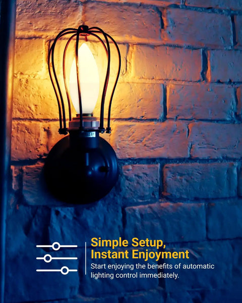 Dusk To Dawn Outdoor LED B11 Candelabra Bulb With Photocell Sensor, 5W Equivalent 40W, 3000K Warm White in a wall sconce at night.