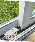 Rock Solid Heavy Duty Double Wheel Sliding Door Pulley Two Pack Stainless Steel Roller Kit installed in patio door track.