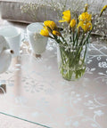 Privacy Window Film With Static Cling Reusable And Removable 17 Inch By 59 Inch Roll applied on glass tabletop with flowers