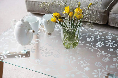 Privacy Window Film With Static Cling Reusable And Removable 17 Inch By 59 Inch Roll applied on glass tabletop with flowers