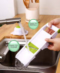 GProMe mandoline slicer, side view; white handheld kitchen tool with green accents over a sink.
