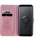 Pink floral smartphone wallet case with card slots open to reveal phone