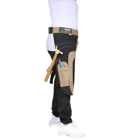 Woman wearing Womens Pro Grade Farrier Aprons Chaps Leather And Canvas 23 Inch Fit With Extra Knee Padding, tools in pockets