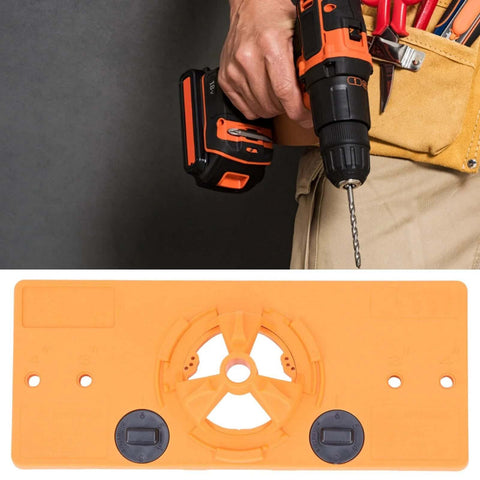 35mm hinge hole jig drill base in orange with circular center guide and two dial knobs; cordless drill with bit in use