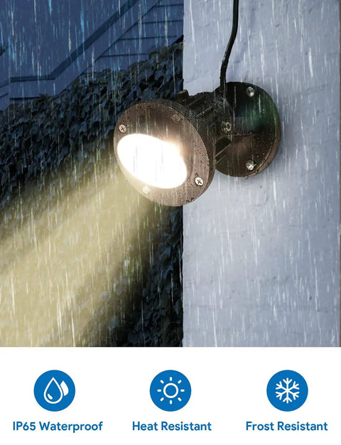 Lit 20W Outdoor COB Landscape Spotlight With Dusk To Dawn Sensor mounted on wall, emitting light in rain, IP65 waterproof, 120V.