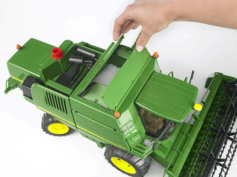 Hand removing grain tank from John Deere T670i Combine Harvester Toy For Kids With Ackermann Steering Tow Bar Realistic Farm Tractor Playset