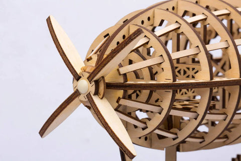 Close-up of laser-cut wood air vehicle with propeller, part of a 3D Jigsaw Puzzle Construction Set DIY Mechanical Model Build Kit