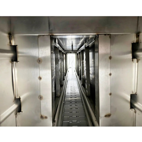 Interior view of Heavy Duty Steam Bottle Sleeve Label Shrinking Machine With 5.6FT Heat Tunnel and 24KW Generator showing the conveyor path.
