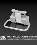 Hands-Free Foot Pedal Cabinet Opener For Frameless Cabinet Doors, compact silver design for kitchens and workshops.