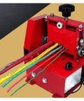 Close-up of Smooth Operator Electric Wire Stripper with colorful wires ready for insulation removal in a red compact machine.