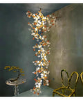 Premium Branch Style Crystal Chandelier With Antique Brass Finish hangs elegantly, illuminating modern room with glass crystals and bronze detail.