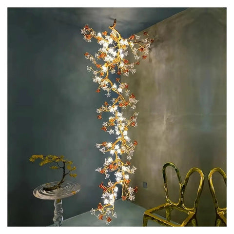 Premium Branch Style Crystal Chandelier With Antique Brass Finish hangs elegantly, illuminating modern room with glass crystals and bronze detail.