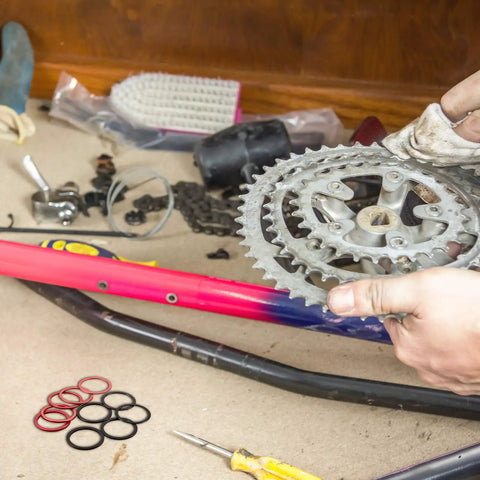 Person installing Aluminum Bike Cassette Spacers And Hub Washers Set For 7 To 11 Speed, tools and parts visible