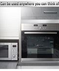 Front view of stainless steel built-in oven with control panel, adjacent stainless microwave in a modern kitchen.