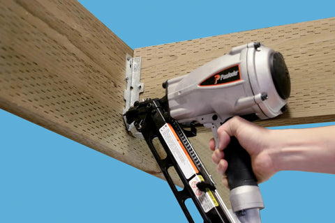 Pro-Grade Strong-Drive 33 SCN Smooth-Shank Connector Nails One And One Half Inch By Point One Four Eight Inch HDG Hot-Dip Galvanized in use with nail gun on wood beam for exterior framing and preservative-treated wood ZMAX Ready 3000 Count