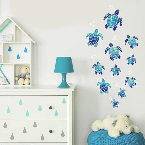 12 Pcs Sea Turtle Wall Decals Set Ocean Turtle Vinyl Stickers in blue on nursery wall, near white drawer and lamp.