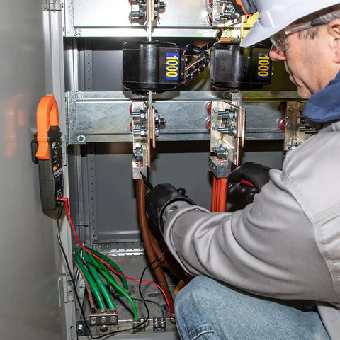 Technician using Magnetic Hanger For Clamp Meters And Multimeters With Powerful Rare Earth Magnets hands-free in electrical panel