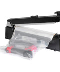 12 Inch Manual Impulse Heat Sealer With Slick Slide Cutter sealing a plastic bag with tool inside, ideal for polyethylene and polypropylene.