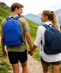 Couple wearing Two-Pack Lightweight Foldable Backpack Set Water-Resistant Packable 20L Travel Hiking Bags in navy and royal blue