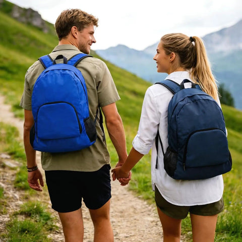 Couple wearing Two-Pack Lightweight Foldable Backpack Set Water-Resistant Packable 20L Travel Hiking Bags in navy and royal blue