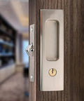 Privacy Pocket Door Lock Hardware With Key For Invisible Barn Doors In Brushed Nickel Finish installed on wooden door