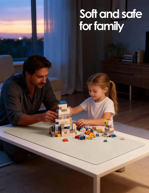 Father and daughter playing with building blocks on a white table at sunset in a cozy living room scene.
