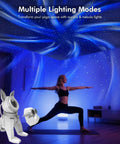 Galaxy Projector Night Light With Music Sync and Northern Lights effects illuminating yoga room with aurora patterns