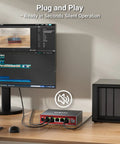Five Port 2.5G Ethernet Switch With 10Gb SFP Plus Uplink for NAS Gaming and PC on desk next to monitor and NAS.