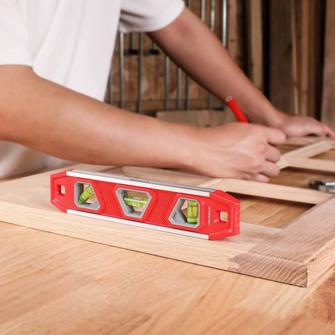 WORKPRO 9-inch torpedo level with three bubble vials, red plastic body for woodworking.
