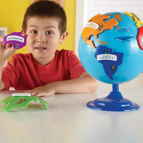 Child with Hands On 3D Puzzle Globe For Kids Learn World Geography With Color Coded Continents And 7 Detachable Puzzle Pieces Plus Name Plates And STEM Ready Kid Friendly Educational Toy For Preschool Classrooms And Home on table