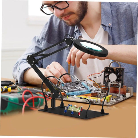 Person using the Six Piece Welding Fixture With Magnifying Glass Lamp Clamp And Circuit Board Holder For Soldering, Durable Iron Build, on desk