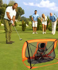 Person using Smart Portable Golf Chipping Net Set With Pop Up Net And Durable Rubber Training Mat outdoors
