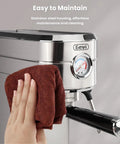 Stainless steel Barista Grade Home Espresso Machine With 20 Bar Pump And Milk Frother being cleaned with a cloth
