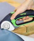Zeite 4 V Cordless Electric Scissors Cardboard Cutter With Two Blades Storage Box Usb Charging Cable Power Rotary Cutter in use on fabric.
