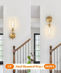 Modern Brushed Gold Wall Sconces Set Of Two With Clear Glass Hardwired Adjustable Up Or Down Vanity Light Fixture For Bathroom Smooth Vibe Upgrade, displayed in upward and downward orientations.