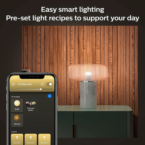 Smart A19 LED Bulb 75W Equivalent in lamp, soft warm white lighting, app control displayed on phone, cozy indoor setting