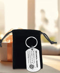 Gearhead Mechanical Engineer Gift Keychain For Students And Pros in stainless steel with black pouch on table