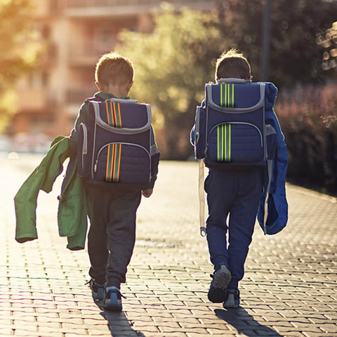 Children walking with backpacks featuring See And Be Seen High Visibility Reflective Tape Strip 2 Inch By 66 Foot Sew On Orange.