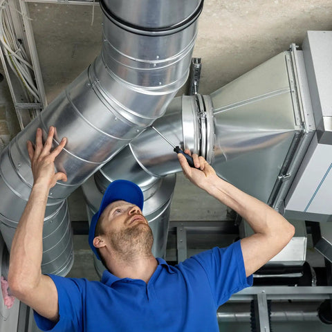 Technician adjusts duct clamp 6 inch V shape 304 stainless steel pipe clamp for ventilation ducting, HVAC system installation