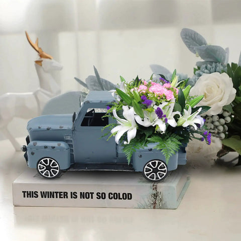 Blue Metal Pickup Truck Decor For Farmhouse Tables holding flowers, handcrafted rustic gift box style, on display book.