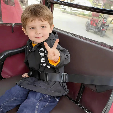 Child wearing two-stage child safety harness for bikes trikes and motorcycles, adjustable safety belt in action