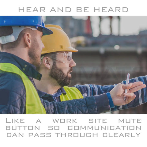 Two construction workers discussing plans while wearing protective gear on site.