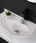 USZWBY Bathroom Vessel Sink Bathroom Crystal Glass Vessel Sink Clear Oval Shape Transparent Basin Bathroom Sink on marble countertop.