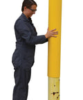Person installing Slide On Yellow Bollard Post Cover For Warehouses Made From Durable Low Density Polyethylene Thermoplastic.