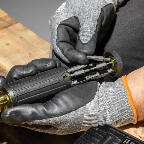 Person holding Grab And Go Multi Bit Tamperproof Screwdriver Kit With Twenty Six Onboard Bits And Quarter Inch Nut Driver Built With Rare Earth Magnets