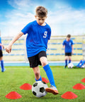 Kid playing soccer with Two 4x3 Ft Portable Pop Up Soccer Goals Backyard Training Set With Ball Pump Cones Ground Nails And Carry Bag