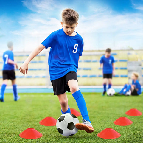 Kid playing soccer with Two 4x3 Ft Portable Pop Up Soccer Goals Backyard Training Set With Ball Pump Cones Ground Nails And Carry Bag