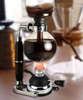 Refillable Butane Mini Burner for tabletop siphon coffee makers with glass globe and stand, pro grade windproof torch head.